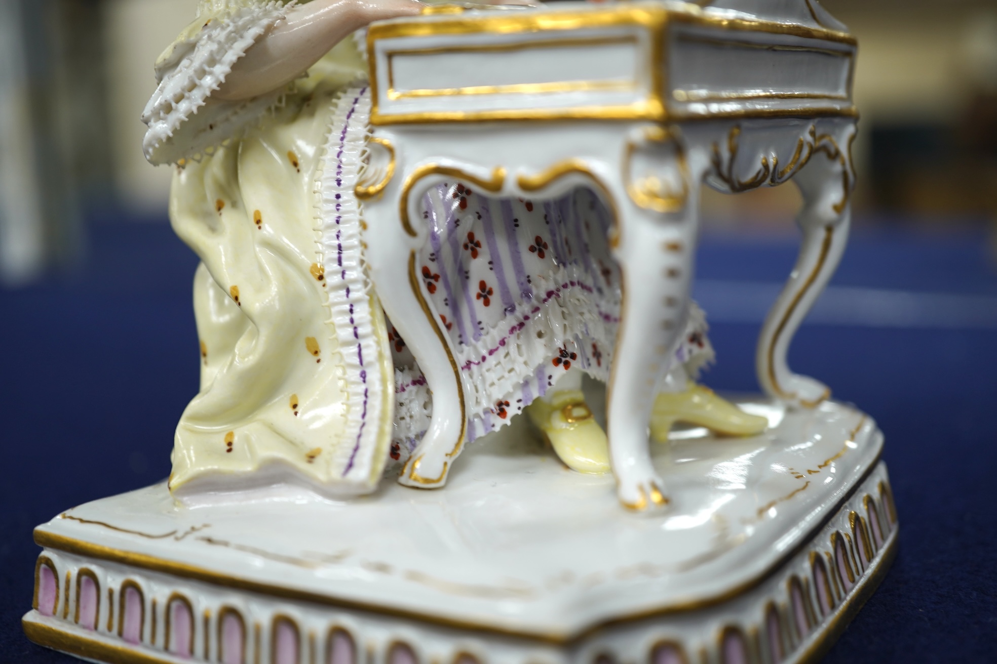 A pair of 19th century Meissen figures of a girl holding a shell and a boy holding a book, in size model number 628, tallest 13cm